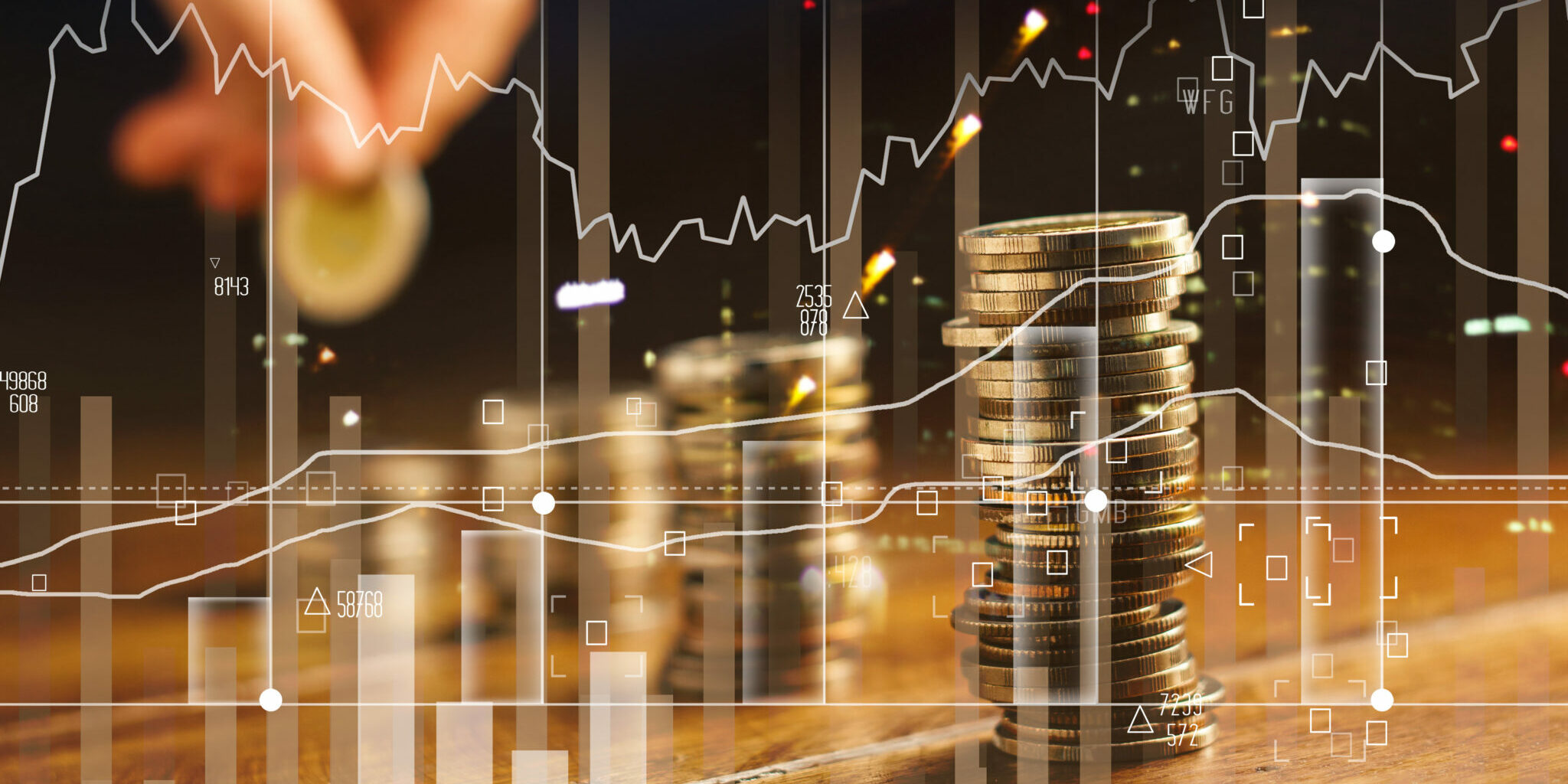 Double exposure. Hand holding golden coin of graph and rows with coins on wooden table. Finance and business concept.