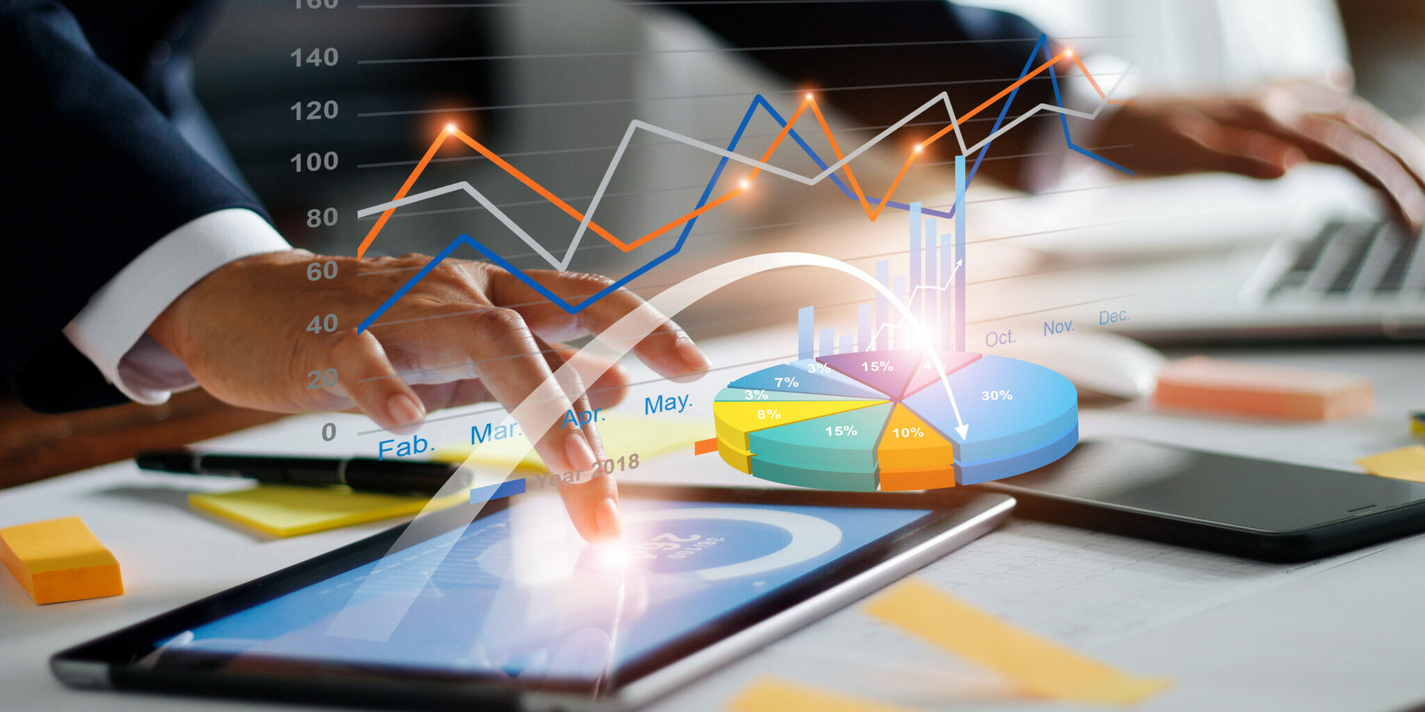 Businessman using tablet and laptop analyzing sales data and economic growth graph chart. Business strategy. Digital marketing. Business innovation technology concept