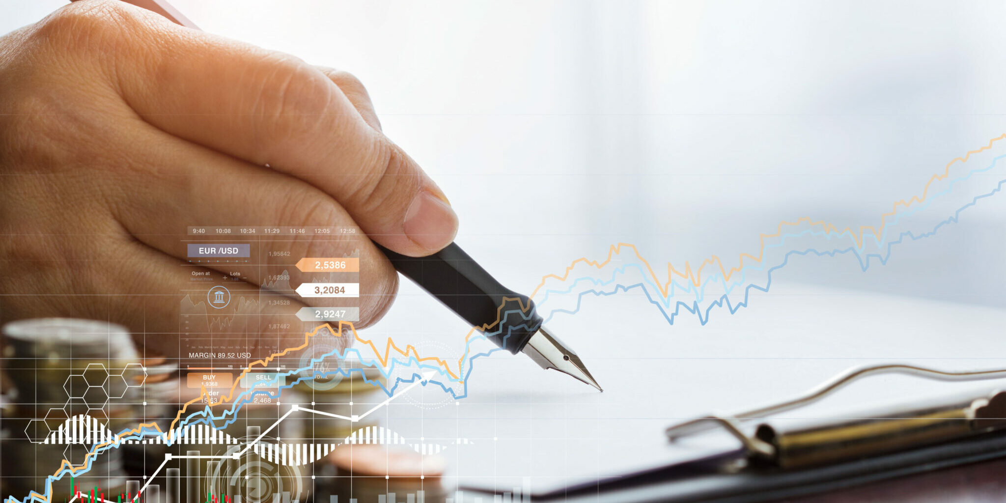 A businessman with a pen is writing finance data and sales on report clipboard paper, along with a growing graph of business. Blogbeitrag